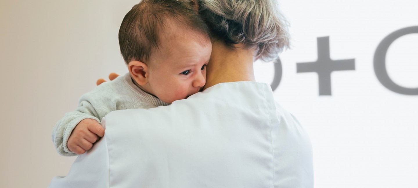 A woman holding a baby